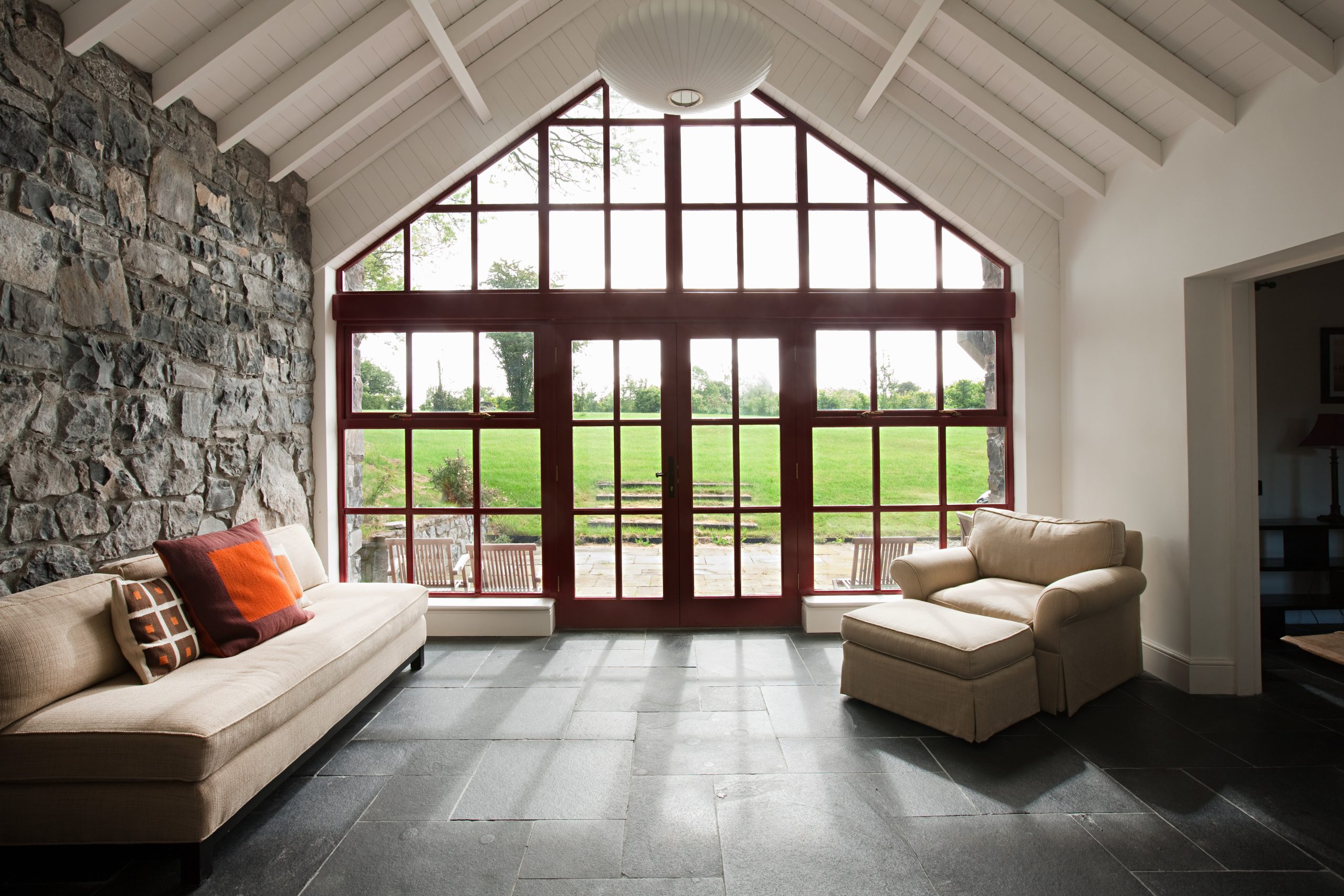 Glazed gable with French doors opening onto a garden