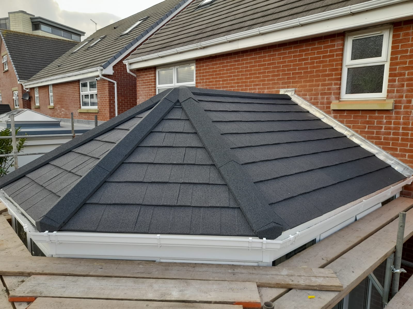 Grey lightweight tiled conservatory roof being fitted