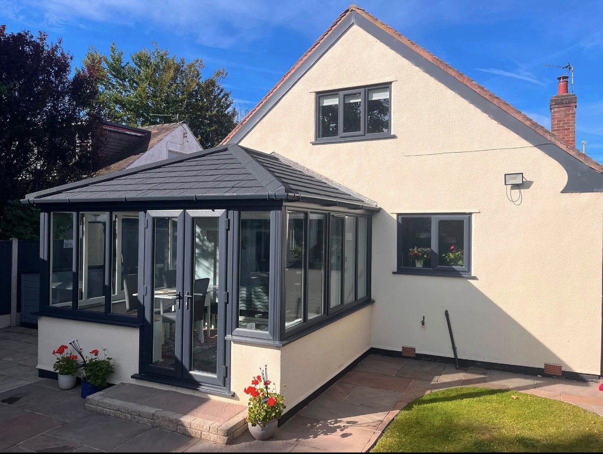 Conservatory with a dark grey tiled replacement roof