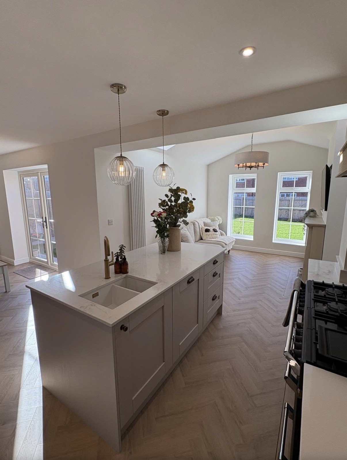 Grey shaker kitchen island in an open plan extension